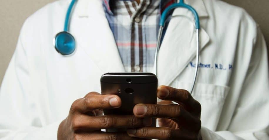 doctor in health care looking at a cellphone