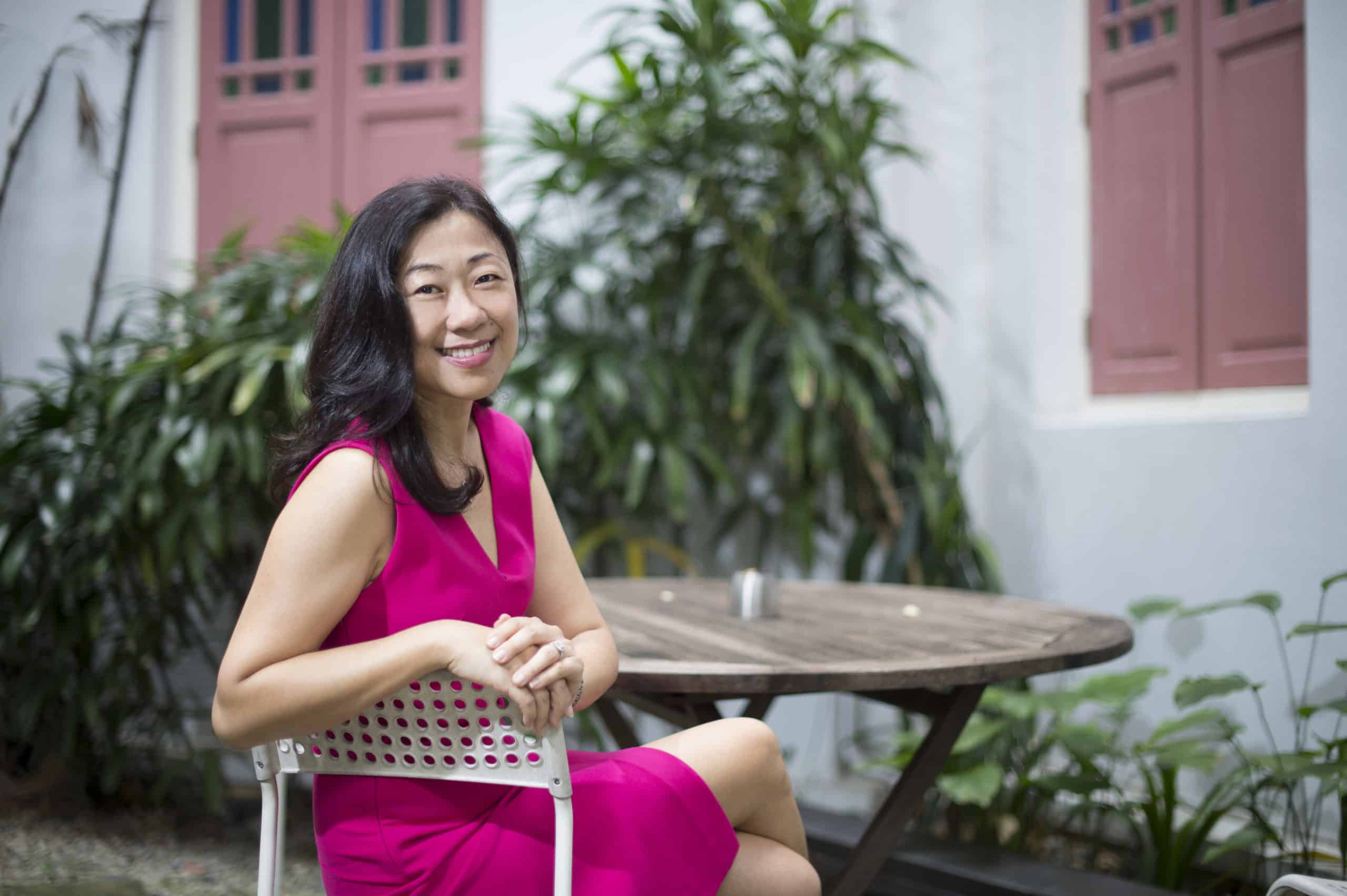 Joanne Wong pink dress seated
