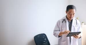 Medical doctor holding a tablet